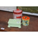 A mixed lot comprising an enamel sugar, jar and lid, bluebird toffee tin and an Art Deco green