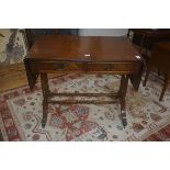 A 19thc style mahogany sofa table, the rectangular top above two frieze drawers on trestle base,