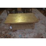 A stripped pine coffee table, the plain rectangular gilded top with plain frieze, block supports,