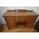 An Edwardian oak ledge back sideboard, the rectangular top with moulded edge, two central doors