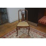 A George II walnut side chair c. 1740 with drop in seat and raised on pad feet.