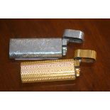 Two Cartier (Paris) Roller gas lighters, one gilt, one white metal (2)