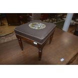 A 19thc mahogany footstool, the upholstered square top with bead work central panel, on plain frieze