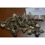 Two silver charm bracelets, a silver gate link bracelet and two curb link bracelets, 136.7g (a lot)