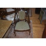 An Edwardian inlaid rosewood horseshoe shaped arm chair, upholstered back panel and slats,