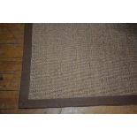 A Crucial Trading sisal rug with woven linen border, 275cm x 201cm