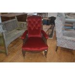 A late 19thc upholstered arm chair, the button back with upholstered arms on turned galleried