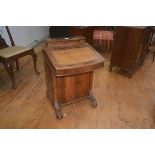 A late 19thc walnut davenport, the top with hinged stationery box, writing slope with inset