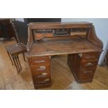 An early 20thc oak roll top desk, on two banks of drawers, 112cm x 122cm x 75cm