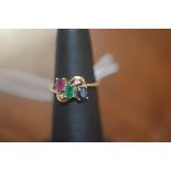 A five stone multi gem set ring with cross over setting, 14ct gold