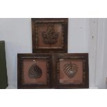 A pair of framed groups of three hardwood carved leaves,each 35.5cm x 35.5cm