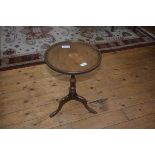 A 19thc style wine table, the circular top on tripod base