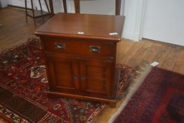 A 19thc style cabinet, the rectangular top with moulded edge, frieze drawer above two panelled