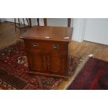 A 19thc style cabinet, the rectangular top with moulded edge, frieze drawer above two panelled