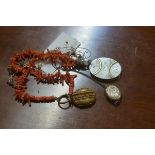 A Victorian engraved silver oval locket, a brass locket on coral necklace and a silver locket on