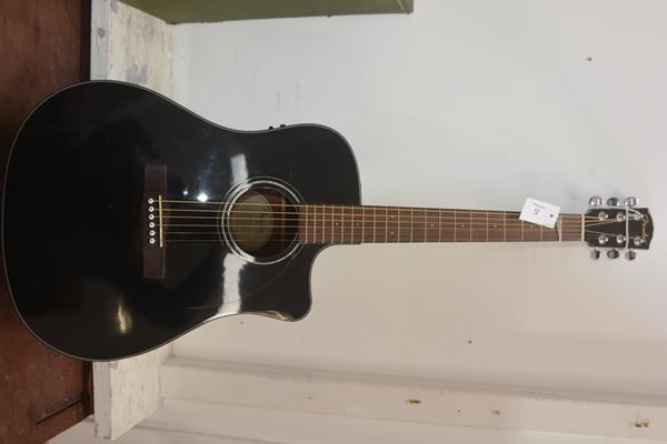 A Fender acoustic six string guitar