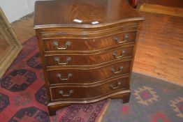 A 19thc style bow fronted walnut chest of drawers, the crossbanded top above a mahogany slide,