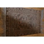 An Afghan prayer rug, the central panel with five panels flanked by flowerhead and geometric border,