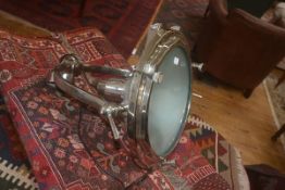 A large white metal theatre style lantern, the horse shoe bracket supporting a circular lantern,