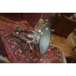 A large white metal theatre style lantern, the horse shoe bracket supporting a circular lantern,