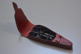 A 19thc gilded and red Morocco scissor case containing three pairs of scissors, with velvet lined in