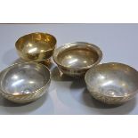 A group of Middle Eastern bronze and brass bowls with engraved decoration (d.16cm and d.14cm) (4), £