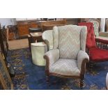 A 19thc mahogany wing chair upholstered in Hungarian style patterned woven fabric, with scroll arms,