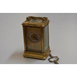 An Edwardian French four glass brass carriage clock with silvered dial and arabic numerals, complete