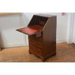 A lady's reproduction mahogany writing bureau, the top with fall front enclosing a fitted interior,