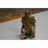 A Chinese mud glazed figure of a monk seated on a tree root (h.14cm), losses to fingers and toes, £2