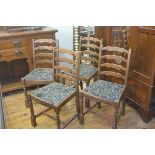 A set of four Ercol ash ladderback dining chairs with slip in seats, raised on turned baluster suppo