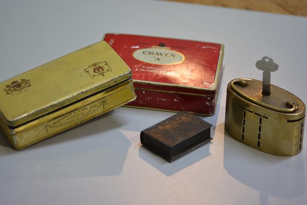 The Union Bank of Manchester oval brass savings bank complete with key, a miniature book box, a ciga