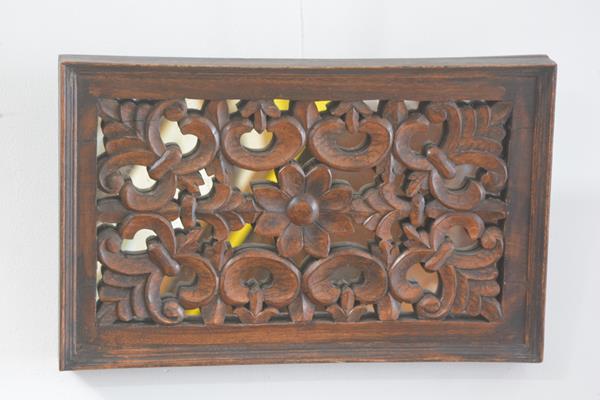 An Eastern rectangular carved mirror panel back panel with flower and stylised leaf design (35cm x 5