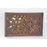 An Eastern rectangular carved mirror panel back panel with flower and stylised leaf design (35cm x 5
