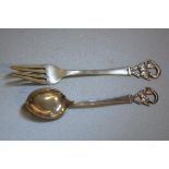 A Norwegian child's Christening fork and spoon set, stamped 830, with terminals cast as mountain goa