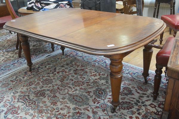 A Victorian walnut telescopic dining table, the top with rounded angles and moulded edge, raised on