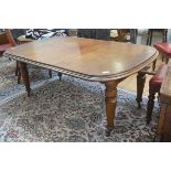A Victorian walnut telescopic dining table, the top with rounded angles and moulded edge, raised on