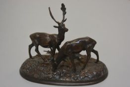 A 19thc cast bronze stag and hind figure group, raised on oval naturalistic base, unsigned (h. 18cm