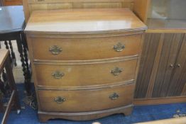 A mahogany reproduction bow front chest, the top with fluted edge above three long drawers, raised o