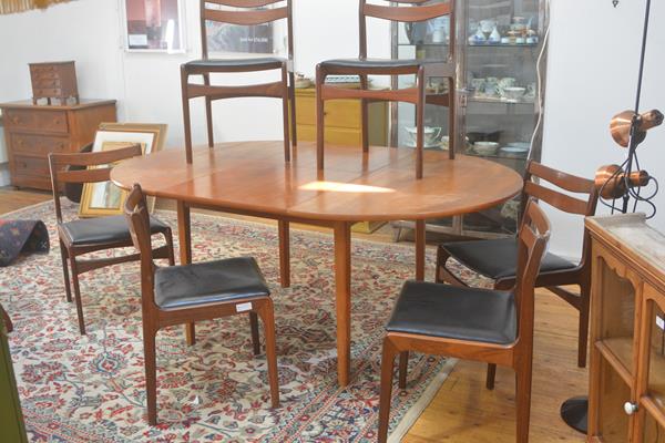 A G Plan 1970s teak seven piece dining suite comprising a circular top extending dining table with m