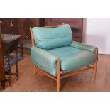 A modern teak framed turquoise leather vintage 1970s style easy chair retailed by Anthropologie, on
