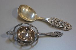 A Norwegian white metal rococco style tea strainer and a Norwegian 830 standard R. Elvesater 1825 ch