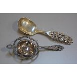 A Norwegian white metal rococco style tea strainer and a Norwegian 830 standard R. Elvesater 1825 ch