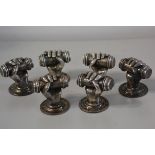 Three pairs of cast brass silvered doorhandles in the form of clenched hands complete with screws et