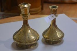 Two Middle Eastern brass panelled lamp bases with bird and stylised flower decoration (h.28cm and h.