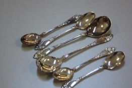 A Norwegian 830 standard 2H.Marthinsen set of four teaspoons and pair of jam spoons, with floral lea