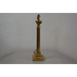 A reproduction brass fluted Corinthian column table lamp, raised on moulded square base (h.39cm), £2