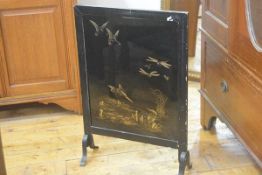 A 1930s ebonised and gilded firescreen with kingfisher and dragonfly design, on metal supports (h. 6