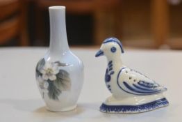 A Copenhagen porcelain bud vase decorated with blackberry design and a Portugese Viana Costelo bird