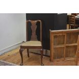 A Queen Anne walnut and elm splat back side chair with slip in seat, raised on carved moulded suppor